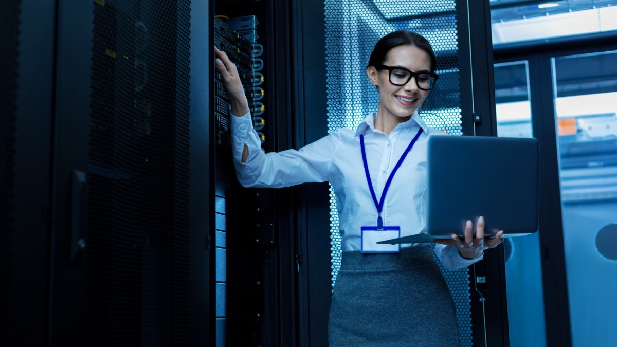 amazing-day-happy-beautiful-woman-working-server-cabinet-holding-her-laptop (1)